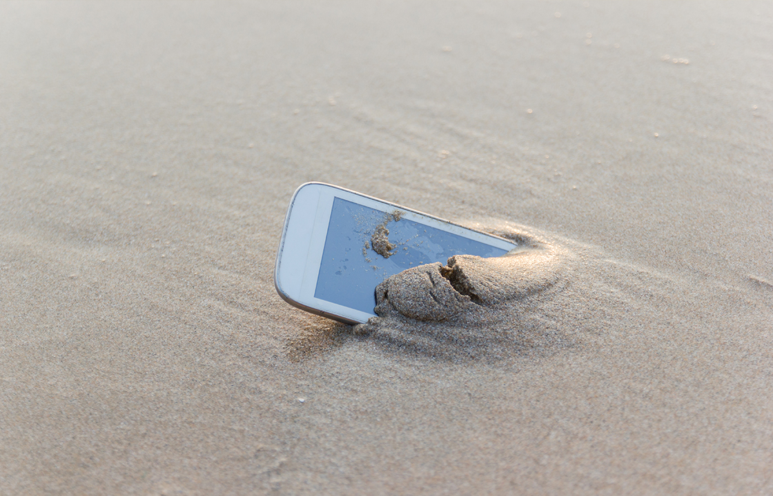 Mobile phone buried in the sand