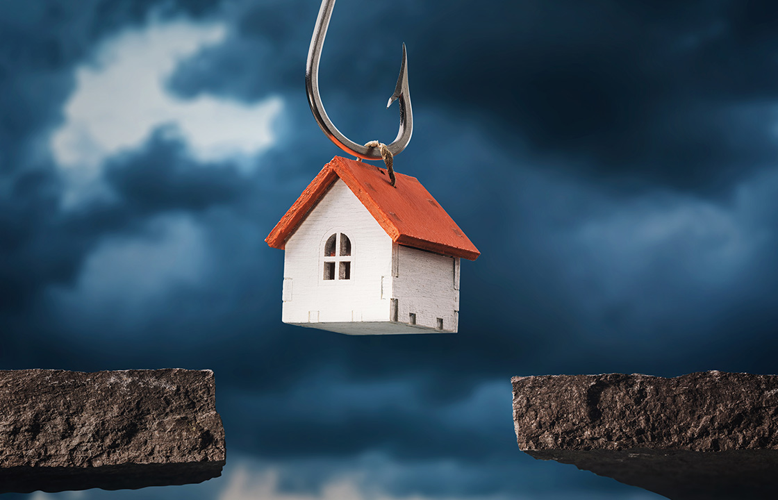 small wooden house on a fishing hook