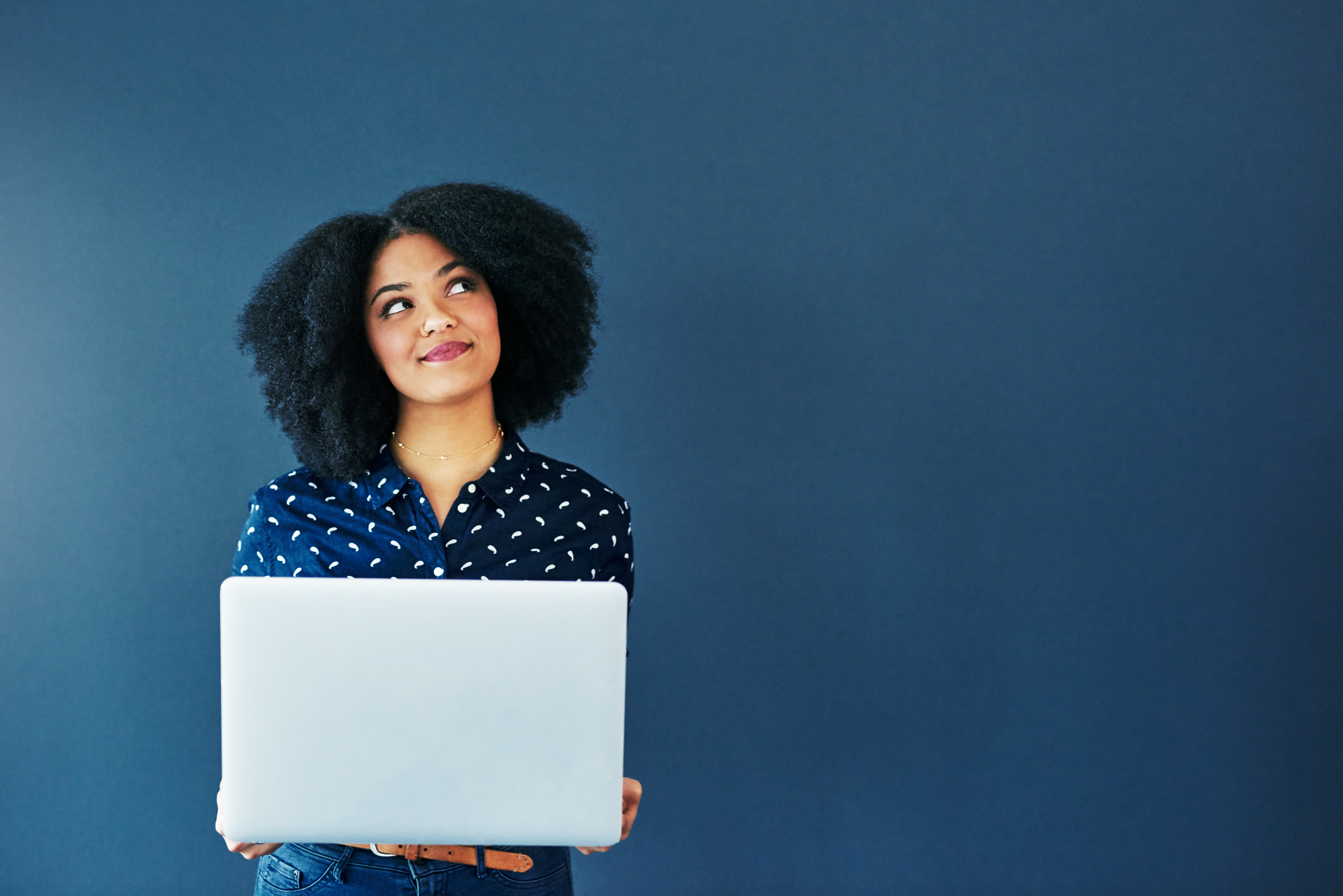 Woman with laptop computer on blue background